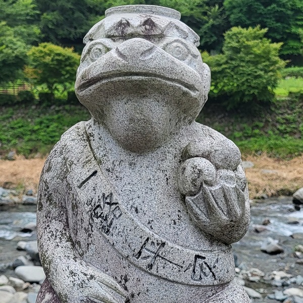 Kappa statue beside a river in Japan