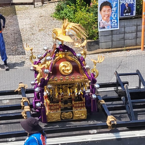 Mikoshi portable shrine being transported through a Japanese town